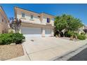 Two-story home with well-maintained lawn and mature landscaping, with a two-car garage at 3873 Palm Island Ct, Las Vegas, NV 89147