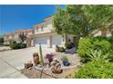 Charming landscaped front yard with mature plants, a tiled walkway and a two car garage at 3873 Palm Island Ct, Las Vegas, NV 89147
