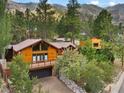 Attractive mountain home with a brown metal roof, large deck, and attached garage at 3935 White Fir Way, Mount Charleston, NV 89124