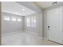 Inviting living room with a large front door, recessed lighting and ample natural light from several windows at 425 Canary Song Dr, Henderson, NV 89011