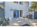 Back patio with an outdoor grill, bench, privacy fence, and a blue double-door entry at 4259 Kona Coast Way, Las Vegas, NV 89121