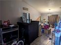 Open living room space with tile flooring, a ceiling fan, and various stored items at 5004 Deep Forest Dr, Las Vegas, NV 89130