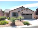 A front elevation of a one-story home with a desert landscaped yard and a two-car garage at 5845 Swan Point Pl, Las Vegas, NV 89122