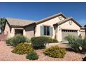 A front elevation of a one-story home with a desert landscaped front yard and a two-car garage at 5845 Swan Point Pl, Las Vegas, NV 89122