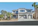 Traditional two-story home showcasing a manicured front lawn and a three-car garage at 600 Baysville Ct, Las Vegas, NV 89144
