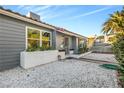 Close up view of a gray-sided single story home with a tile roof and white rock landscaping at 620 Avenue H, Boulder City, NV 89005