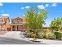 Inviting home featuring a landscaped front yard and a concrete driveway leading to the garage at 6636 Surfbird St, North Las Vegas, NV 89084