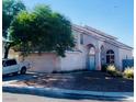 Attractive stucco home featuring arched entry, tile roof, desert landscaping, and an attached two-car garage at 7528 Golden Yucca Dr, Las Vegas, NV 89147