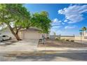 Beautiful single story home with two-car garage, desert landscaping and a mature shade tree on a corner lot at 7528 Golden Yucca Dr, Las Vegas, NV 89147