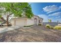 Beautiful one-story home with low maintenance desert landscaping and two-car garage, located on a corner lot at 7528 Golden Yucca Dr, Las Vegas, NV 89147