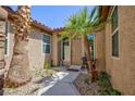 Inviting front entrance with desert landscaping, decorative plants, and a neutral-colored front door at 7609 Slide Rock Ave, Las Vegas, NV 89113