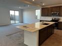 Modern kitchen with a large island, stainless steel appliances, and a sliding glass door leading to the backyard at 8020 Texas Hills St, Las Vegas, NV 89113