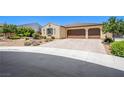 Inviting single-story home with a two-car garage, complemented by a brick-paved driveway at 8298 W Agate Ave, Las Vegas, NV 89113