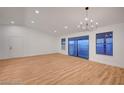 Spacious living room features hardwood floors, ample natural light, and sliding glass doors leading to outdoor space at 8412 Mulcahy Ave, Las Vegas, NV 89145
