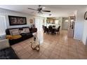 Open concept living area featuring tile flooring, comfortable seating, and a dining space at 8898 Promised Land Ave, Las Vegas, NV 89148