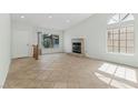 Bright living room with tile flooring, a fireplace, and large windows at 9116 Cypress Point Way, Las Vegas, NV 89117