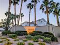 The La Paz community sign is surrounded by mature landscaping and palm trees at 9728 Echo Hills Dr, Las Vegas, NV 89134