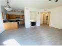Bright living room featuring new flooring, a fireplace and an open concept kitchen at 10290 Gilmore Canyon Ct # 103, Las Vegas, NV 89129