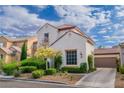 Two-story home with a tile roof and attached garage at 10987 Santorini Dr, Las Vegas, NV 89141
