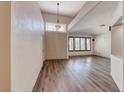 Inviting living room featuring vaulted ceilings, wood-look flooring, and bright window views at 1126 Winter Storm Dr, Henderson, NV 89052
