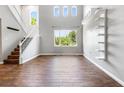 Bright, open-concept living room with hardwood floors, lots of natural light, and high ceilings at 11375 Ogden Mills Dr # 103, Las Vegas, NV 89135