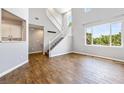 Spacious living area with hardwood floors and natural light beaming through the windows at 11375 Ogden Mills Dr # 103, Las Vegas, NV 89135
