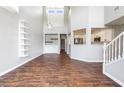 Open floor plan with tile backsplash, high ceilings, hardwood floors, and lots of natural light at 11375 Ogden Mills Dr # 103, Las Vegas, NV 89135