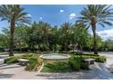 Beautiful community park fountain surrounded by palm trees, benches, and green landscaping at 1204 Moselle Ct, Las Vegas, NV 89144