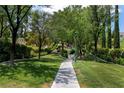 Well-maintained community park walkway surrounded by lush greenery and mature trees at 1204 Moselle Ct, Las Vegas, NV 89144