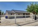 View of home showcasing the backyard and rear exterior, accented by a secure white fence at 125 S 15Th St, Las Vegas, NV 89101
