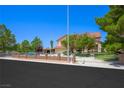Attractive stucco home with iron gate and mature trees creates a nice curb appeal on a clear day at 1345 Morning Sun Way, Las Vegas, NV 89110