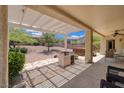 Outdoor space featuring covered patio, built-in grill, lush landscaping and spa at 1620 Fieldbrook St, Henderson, NV 89052