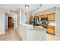 Cozy kitchen with stainless steel appliances, granite countertops, wooden cabinets, and a breakfast bar at 2108 Calville St # 104, Las Vegas, NV 89128