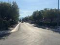 Scenic street view lined with mature trees and manicured landscaping at 228 Caracas Dr, Las Vegas, NV 89145
