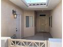 The front courtyard includes a white security gate, a skylight, and a front door with a screen at 3161 Quail Song Dr # 3161, Laughlin, NV 89029