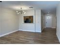 Open-concept living room with wood floors, modern lighting, and a passthrough to the kitchen at 3161 Quail Song Dr # 3161, Laughlin, NV 89029
