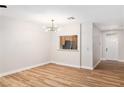 Bright living room with wood floors, modern lighting, and opening to the kitchen at 3161 Quail Song Dr # 3161, Laughlin, NV 89029