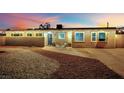 Charming home exterior at dusk featuring updated landscaping, lighting, and cozy front porch at 3509 Navajo Way, Las Vegas, NV 89108