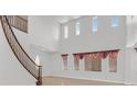Bright living room showcasing a high ceiling, natural light, and staircase at 3689 Bufflehead St, Las Vegas, NV 89122