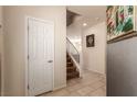 Bright entryway with tile flooring, coat closet and staircase to the second floor at 389 Fringe Ruff Dr, Las Vegas, NV 89148
