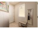 Cozy entryway features tile flooring, a bench, and a large mirror at 389 Fringe Ruff Dr, Las Vegas, NV 89148