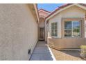 Inviting front entryway with security door, accent window, and stucco facade at 4369 Meadowlark Wing Way, North Las Vegas, NV 89084