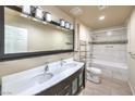 Bright bathroom with double sinks, a large mirror, and a tiled shower-tub combination at 4428 Los Reyes Ct, Las Vegas, NV 89121