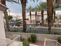 Exterior view displaying the community's landscape with lush palm trees and surrounding buildings at 4555 E Sahara Ave # 288, Las Vegas, NV 89104
