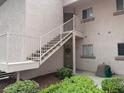 Building exterior showcasing staircase access to upper units and well-manicured shrubs at 4555 E Sahara Ave # 288, Las Vegas, NV 89104