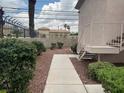 A walkway leading to the building's entrance surrounded by verdant shrubs and landscaping at 4555 E Sahara Ave # 288, Las Vegas, NV 89104
