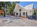 Charming white home with A-frame roof, covered porch, stone paver driveway, and basketball hoop at 4778 Knotty Pine Way, Las Vegas, NV 89124
