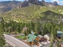 Scenic aerial view of a wooded mountain neighborhood, featuring cozy cabins with green roofs and mountain views at 4830 Silver Tip Way, Mount Charleston, NV 89124