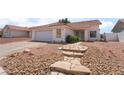 Charming single-story home featuring a two-car garage and low maintenance desert landscaping at 521 Landra Ln, Henderson, NV 89015