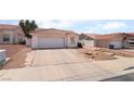 Charming single-story home featuring a two-car garage and low maintenance desert landscaping at 521 Landra Ln, Henderson, NV 89015